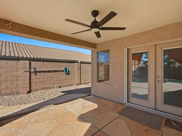 a view of a hallway with a ceiling fan