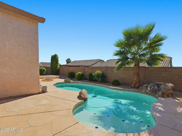 a backyard of a house with table and chairs