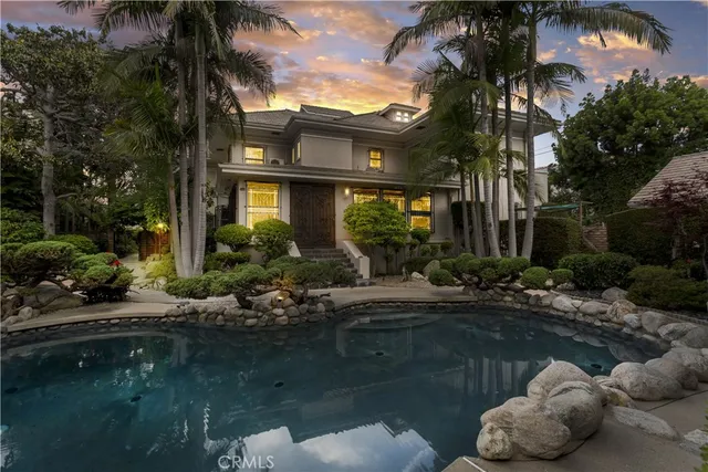 a view of a hallway with wooden floor and a chandelier