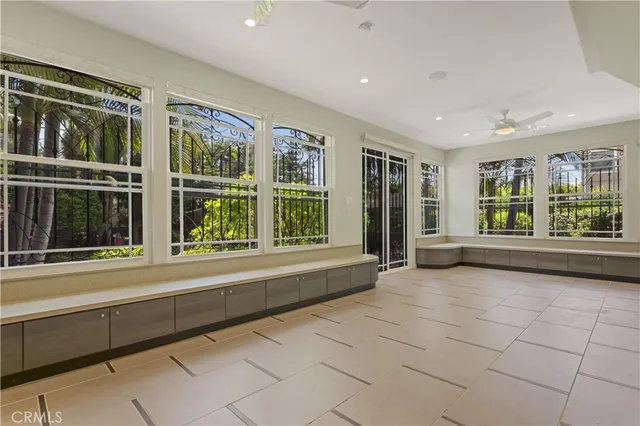 a view of an empty room with window and cabinet