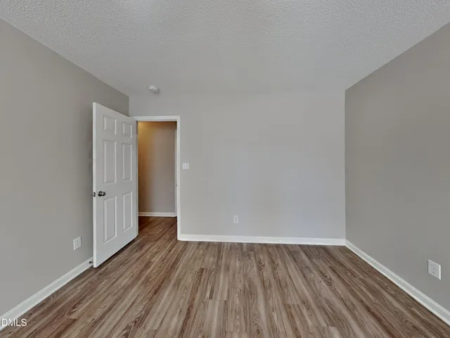 a view of a room with wooden floor and white doors