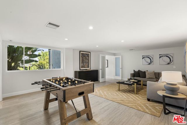 a living room with furniture a rug and a flat screen tv