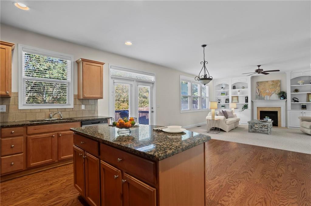 4250 Granby Circle Cumming, GA 30041 - Photo 15 of 37 a kitchen with granite countertop a sink stove and cabinets