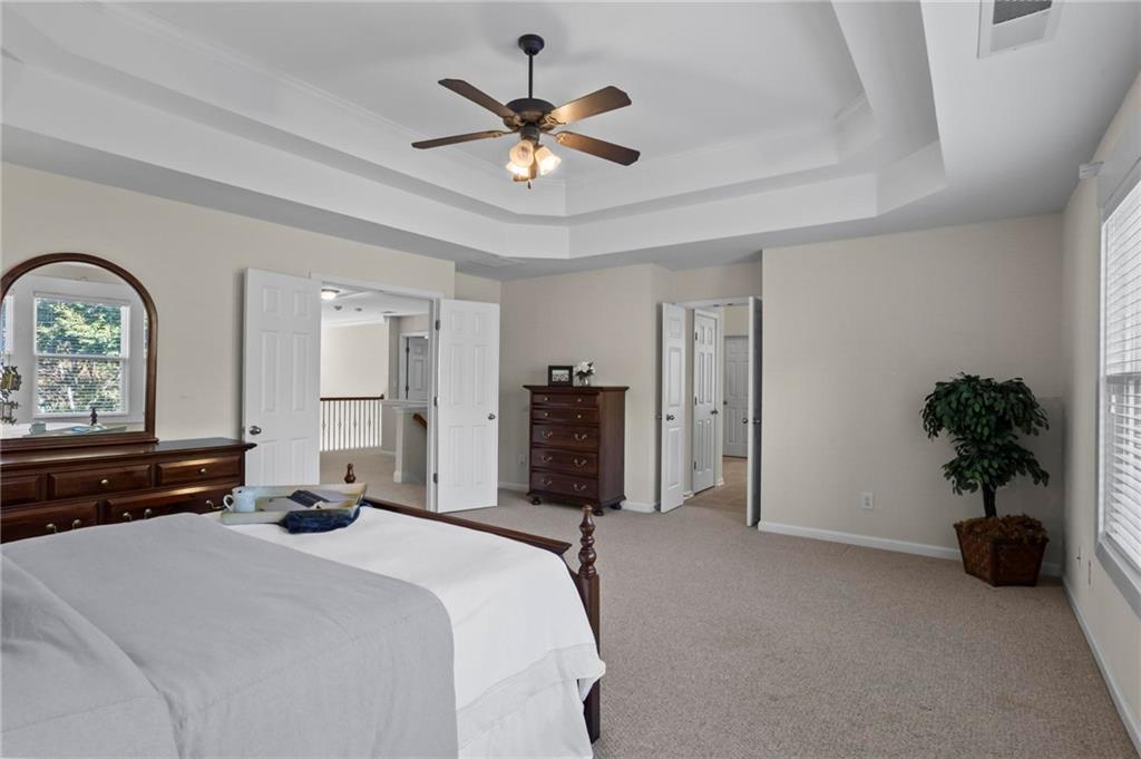 4250 Granby Circle Cumming, GA 30041 - Photo 21 of 37 a bedroom with a bed and a chandelier