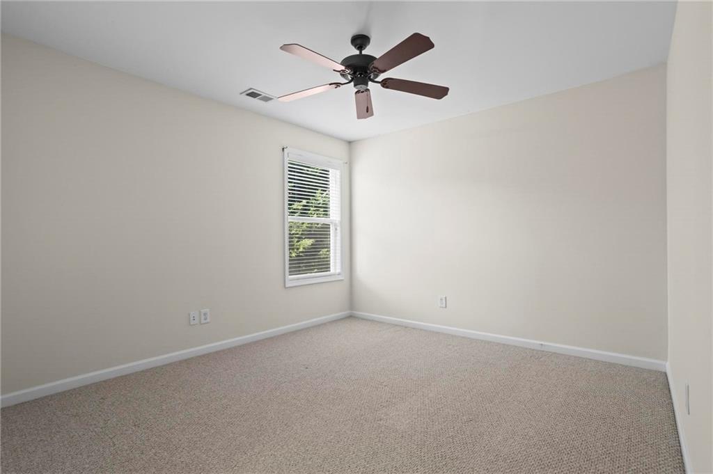 4250 Granby Circle Cumming, GA 30041 - Photo 26 of 37 an empty room with a window and a ceiling fan