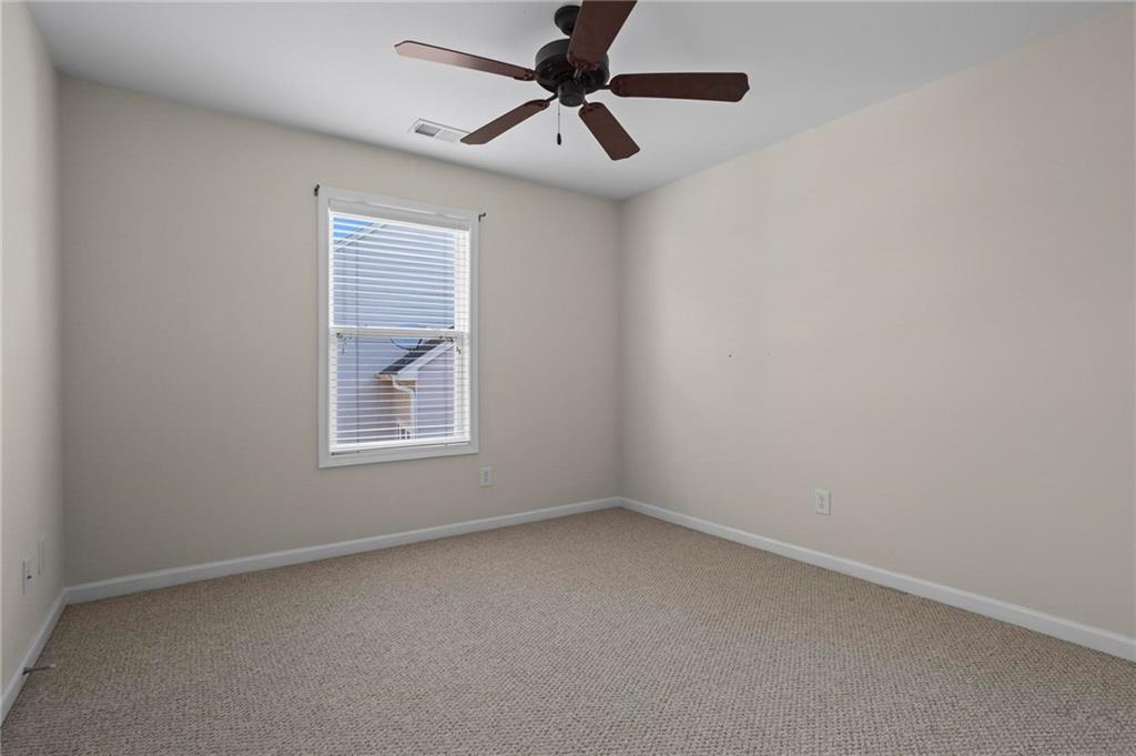 4250 Granby Circle Cumming, GA 30041 - Photo 31 of 37 an empty room with a window and a fan