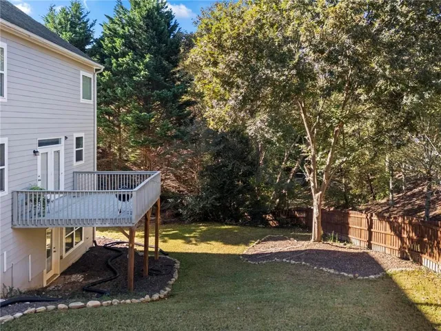a view of backyard with swimming pool