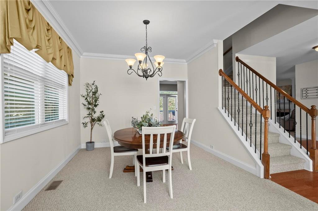 4250 Granby Circle Cumming, GA 30041 - Photo 8 of 37 a dining room with furniture a chandelier and window