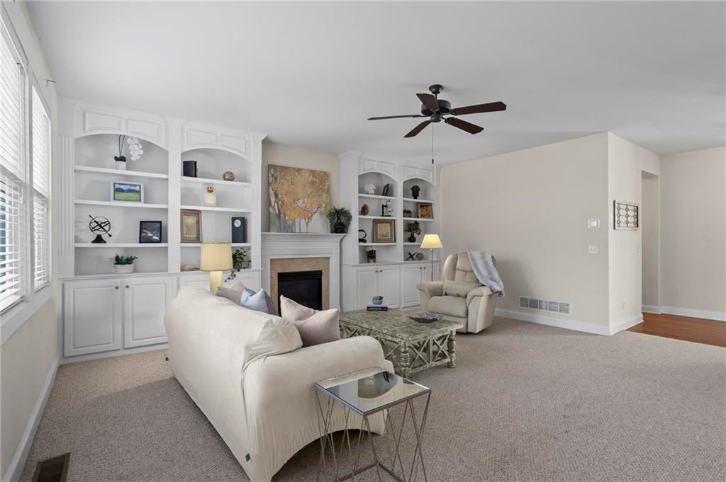 4250 Granby Circle Cumming, GA 30041 - Photo 10 of 37 a living room with furniture a fireplace and a window