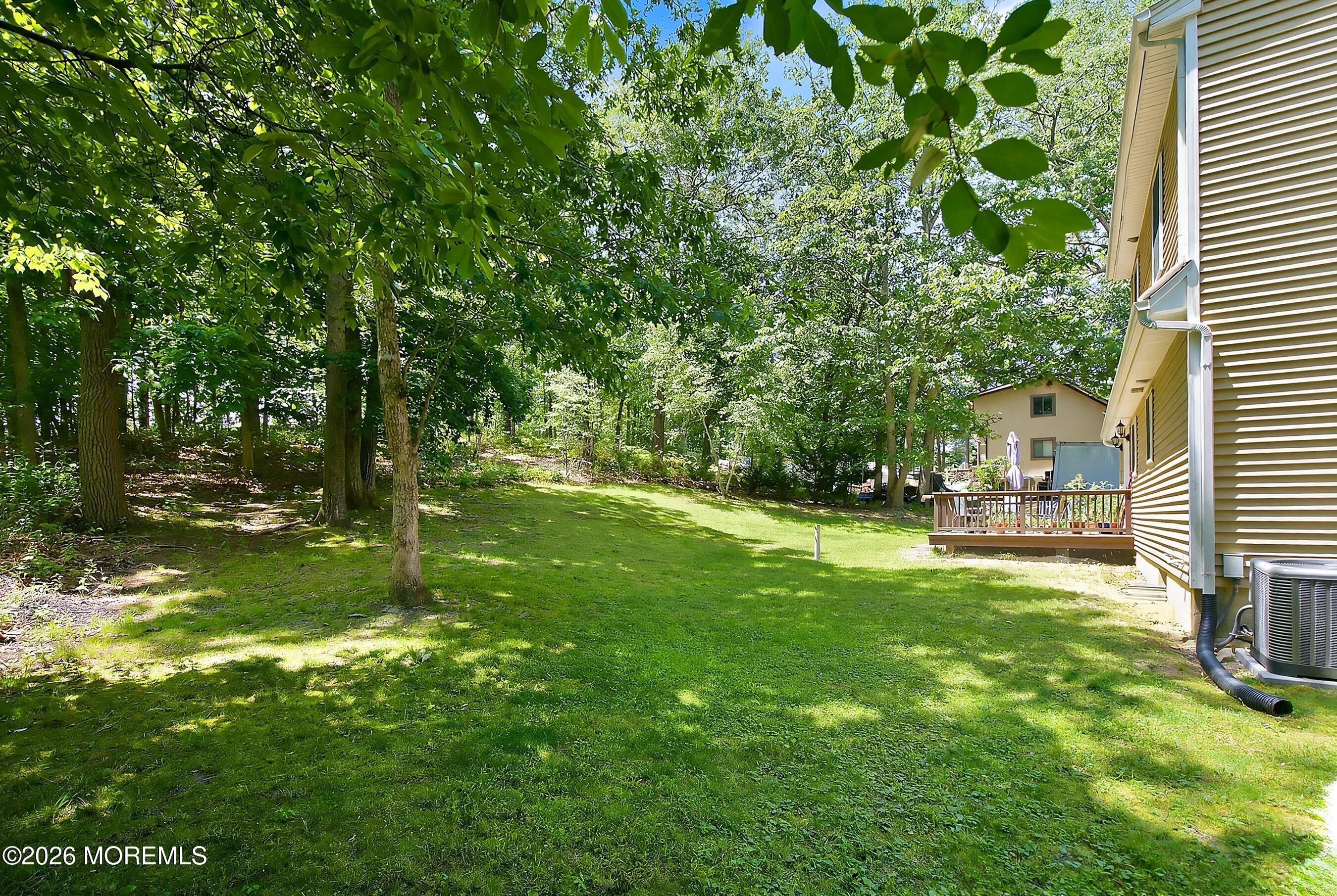 935 Bethel Church Road Jackson, NJ 08527 - Photo 30 of 32 a backyard of a house with table and chairs
