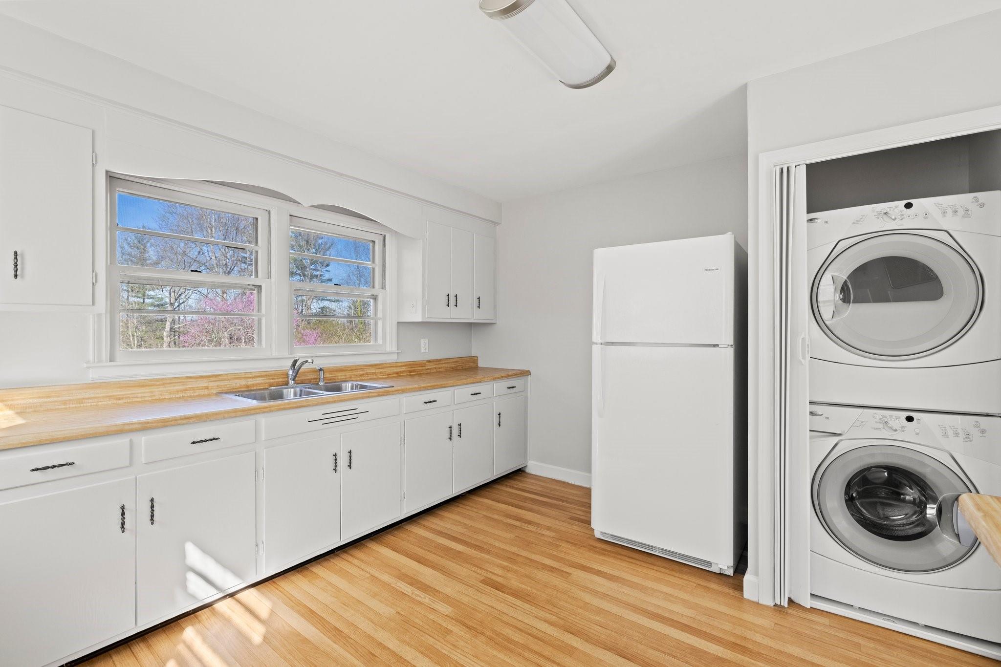 480 Loop Road Hendersonville, NC 28792 - Photo 12 of 26 a kitchen with cabinets a washer and dryer