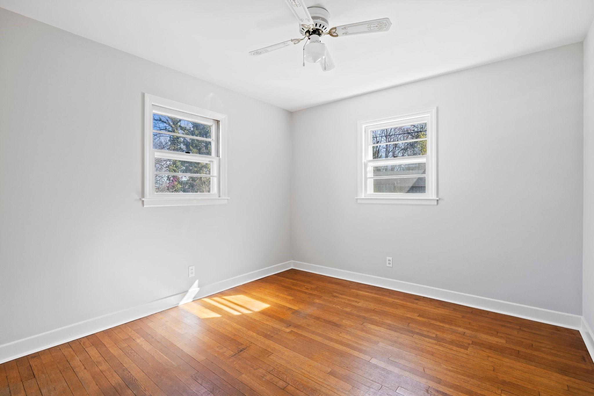 480 Loop Road Hendersonville, NC 28792 - Photo 16 of 26 a view of empty room with wooden floor and fan