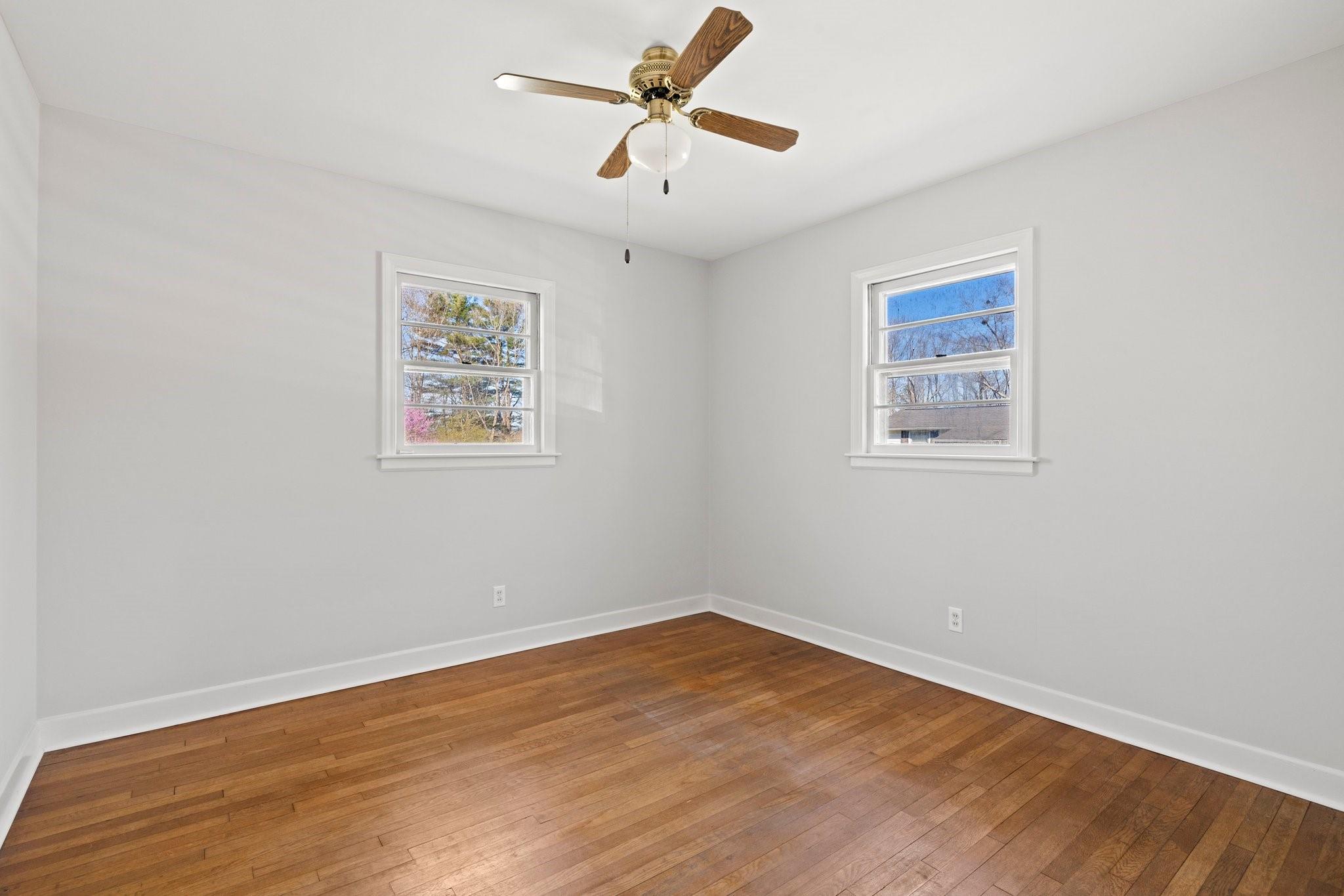 480 Loop Road Hendersonville, NC 28792 - Photo 18 of 26 an empty room with wooden floor and ceiling fan