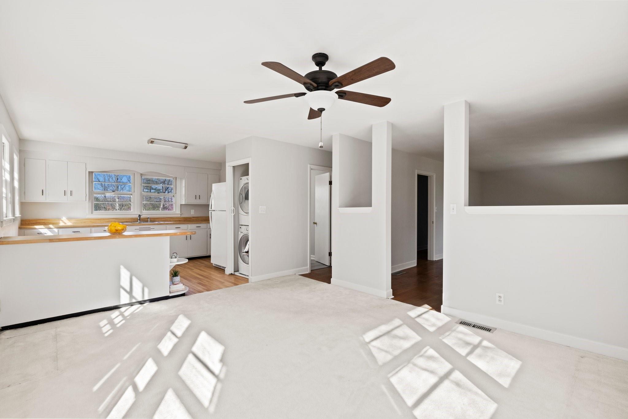 480 Loop Road Hendersonville, NC 28792 - Photo 9 of 26 a view of a kitchen with wooden floor and a ceiling fan
