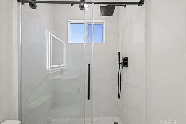 a bathroom with a toilet a sink a mirror and vanity