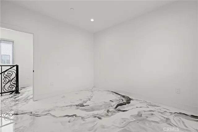 a view of a bedroom with a bed and a window