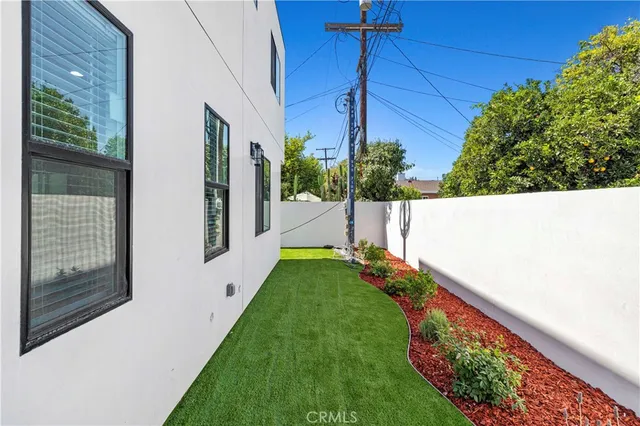 a front view of a house with a garden and yard