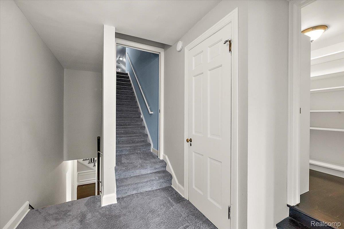 1051 Devonshire Road Grosse Pointe, MI 48230 - Photo 51 of 99 Carpeted staircase with white handrail and light blue wall color