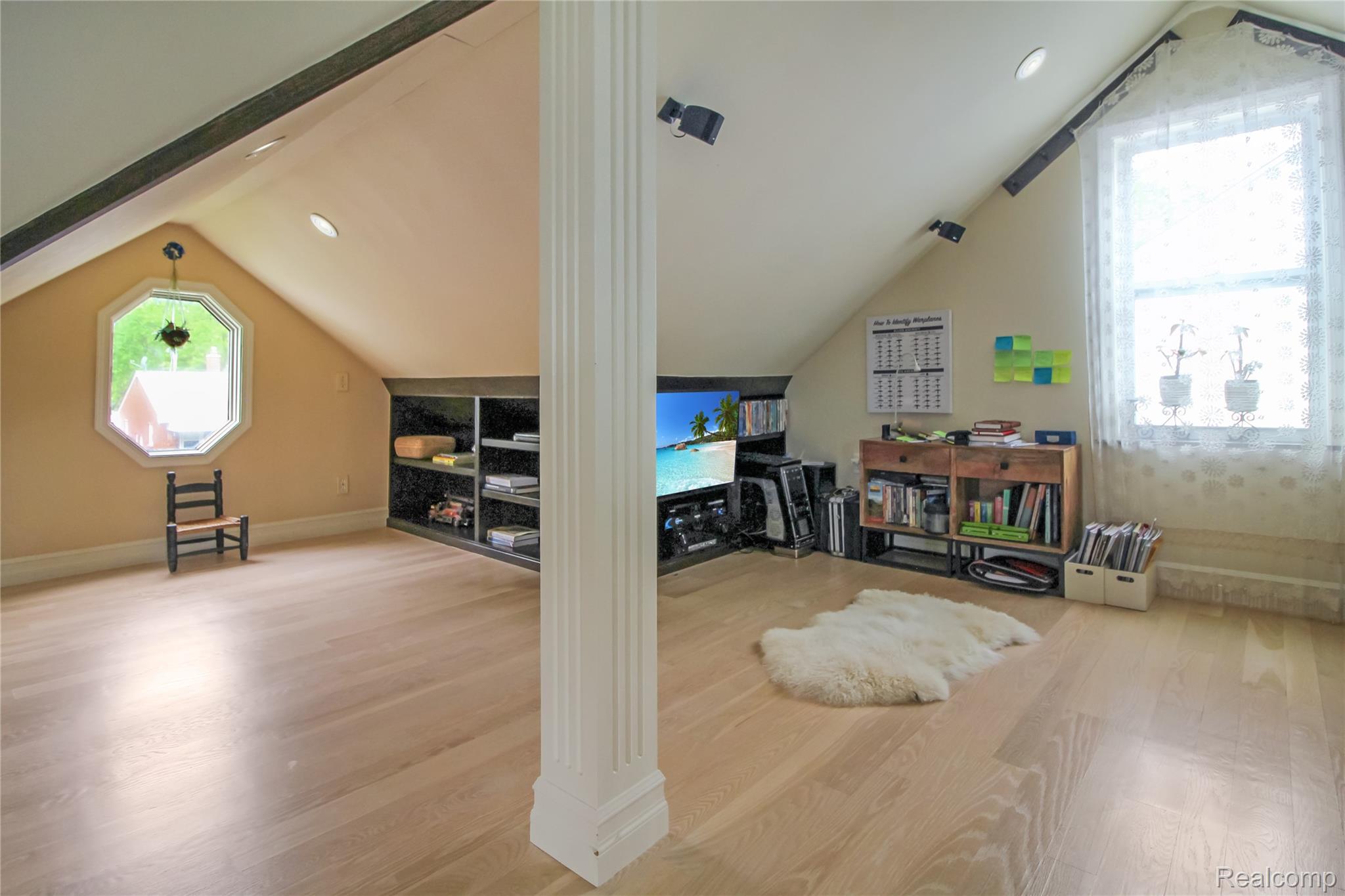 5953 Cooper Street Taylor, MI 48180 - Photo 30 of 33 Attic space featuring wood-finish flooring, an octagonal window, and an additional rectangular window