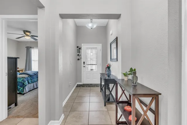a kitchen with refrigerator and chairs