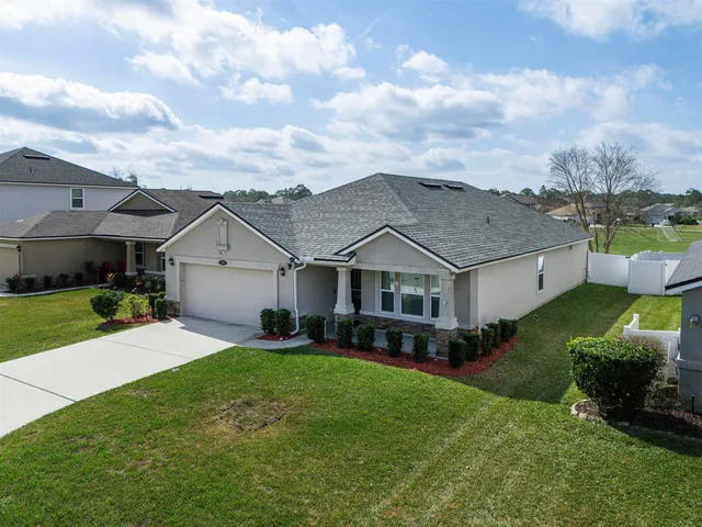 a front view of a house with a yard and garage