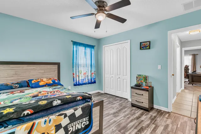 a bedroom with a bed and a chandelier