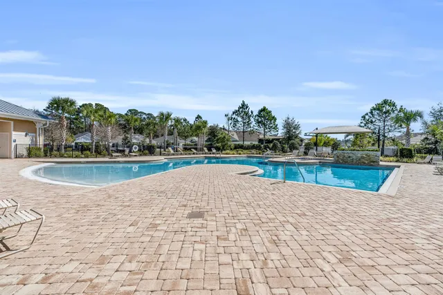a view of a house with a yard and potted plants