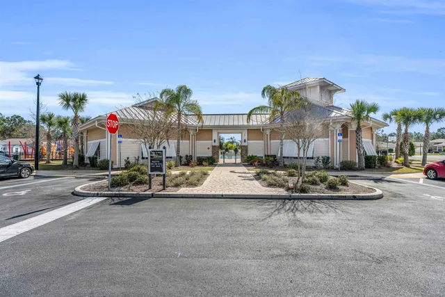 a view of a house with a large window and flower on the wooden wall