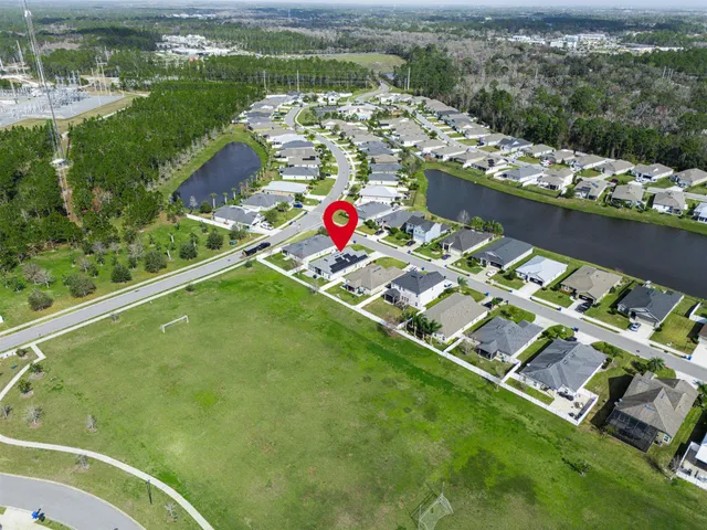 an aerial view of residential houses with outdoor space and swimming pool