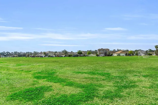 a kitchen with stainless steel appliances granite countertop a stove a refrigerator a oven a sink a dining table and chairs