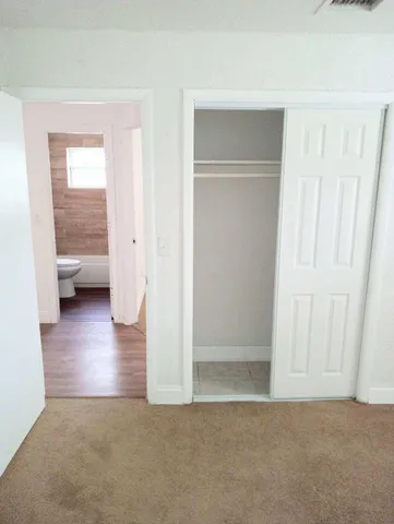 a view of a room with a furniture and wooden floor