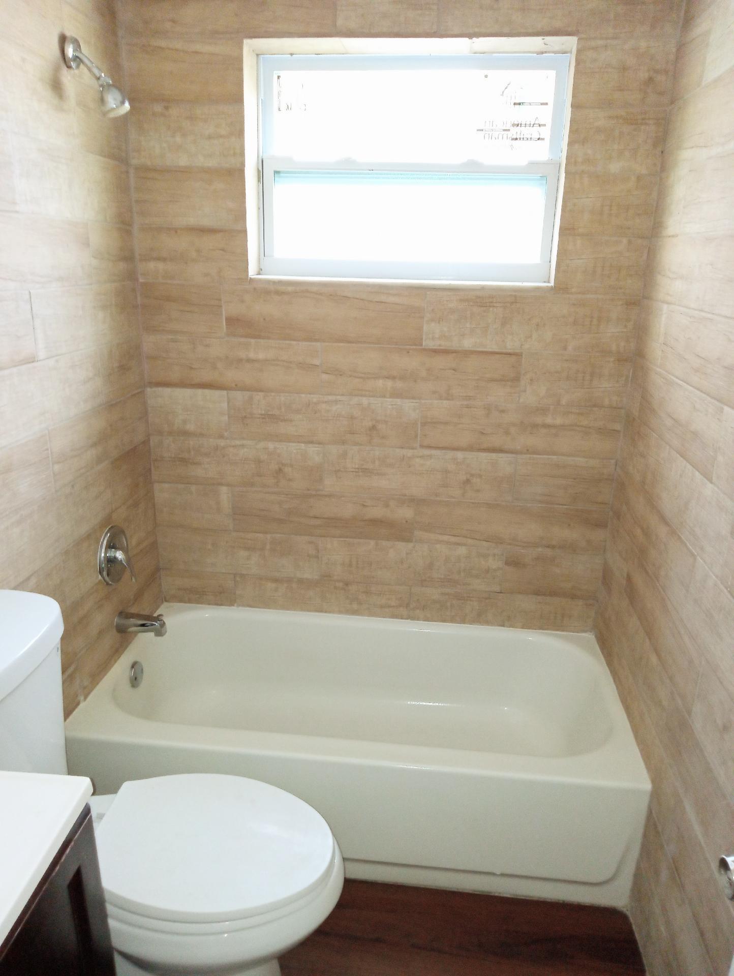 305 Northwest 4th Avenue Delray Beach, FL 33444 - Photo 19 of 45 a bathroom with a bathtub and a toilet