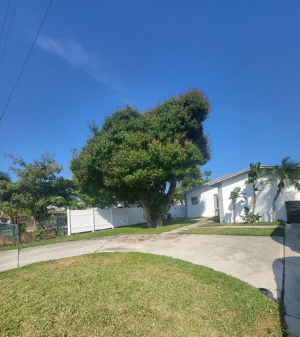 a view of yard with swimming pool and green space
