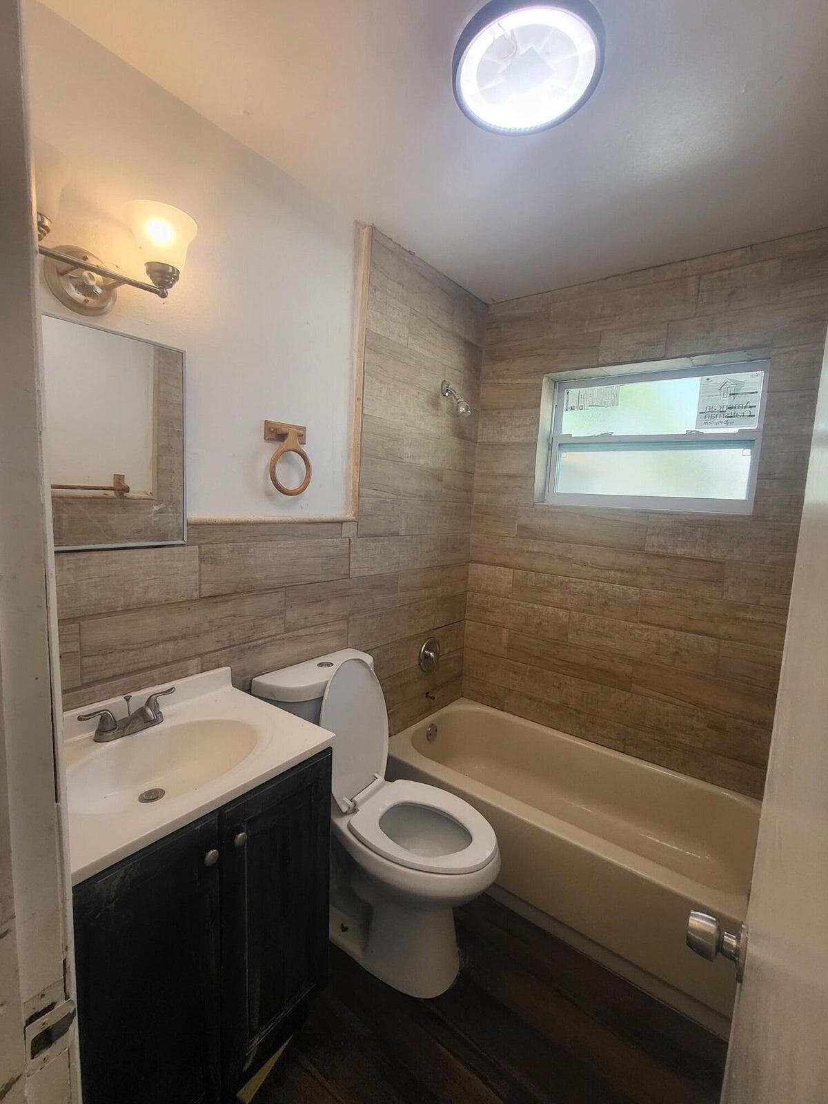305 Northwest 4th Avenue Delray Beach, FL 33444 - Photo 25 of 45 a bathroom with a sink a toilet and shower