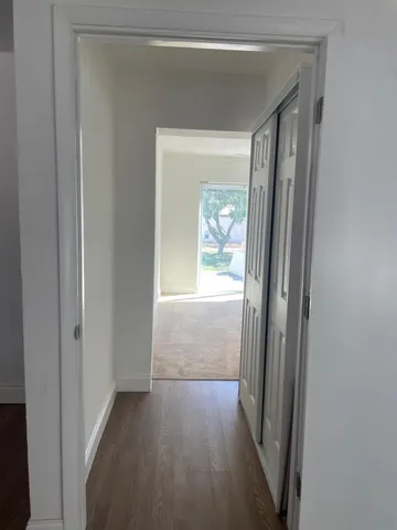 a view of a room with wooden floor
