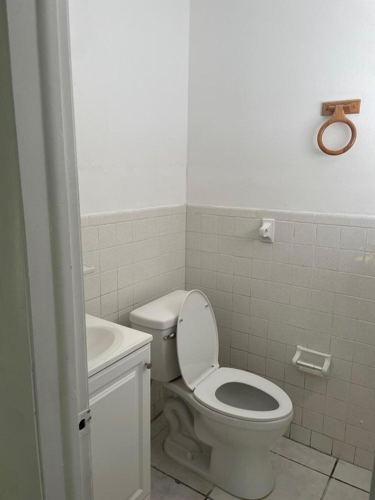 305 Northwest 4th Avenue Delray Beach, FL 33444 - Photo 35 of 45 a white toilet sitting next to a white sink