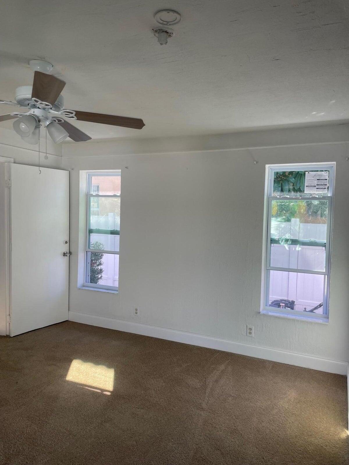 305 Northwest 4th Avenue Delray Beach, FL 33444 - Photo 37 of 45 an empty room with windows and fan