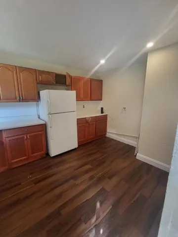 a kitchen with a stove sink and cabinets