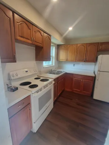a room with wooden floor and cabinets