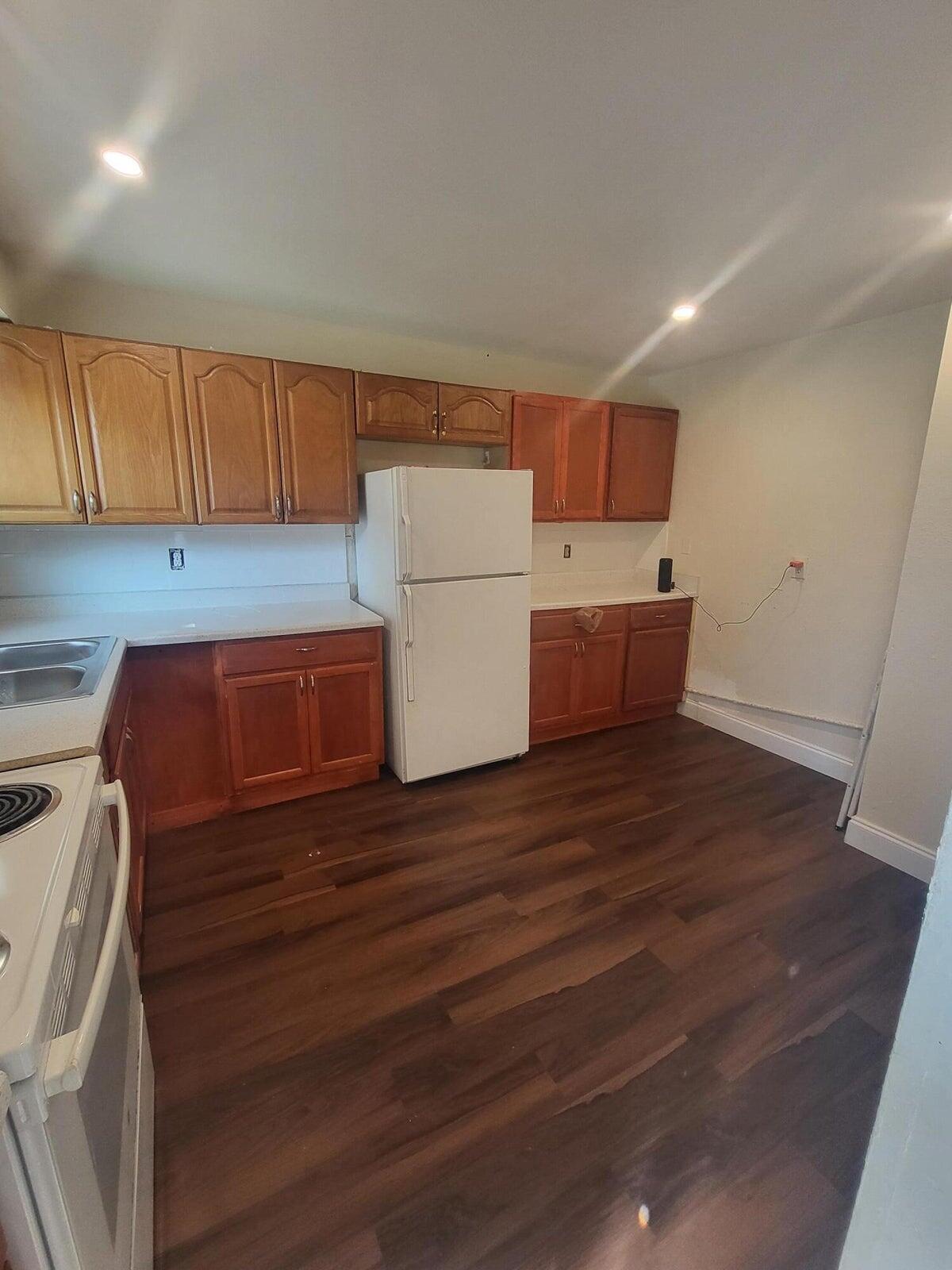 305 Northwest 4th Avenue Delray Beach, FL 33444 - Photo 43 of 45 a room with wooden floor and cabinets
