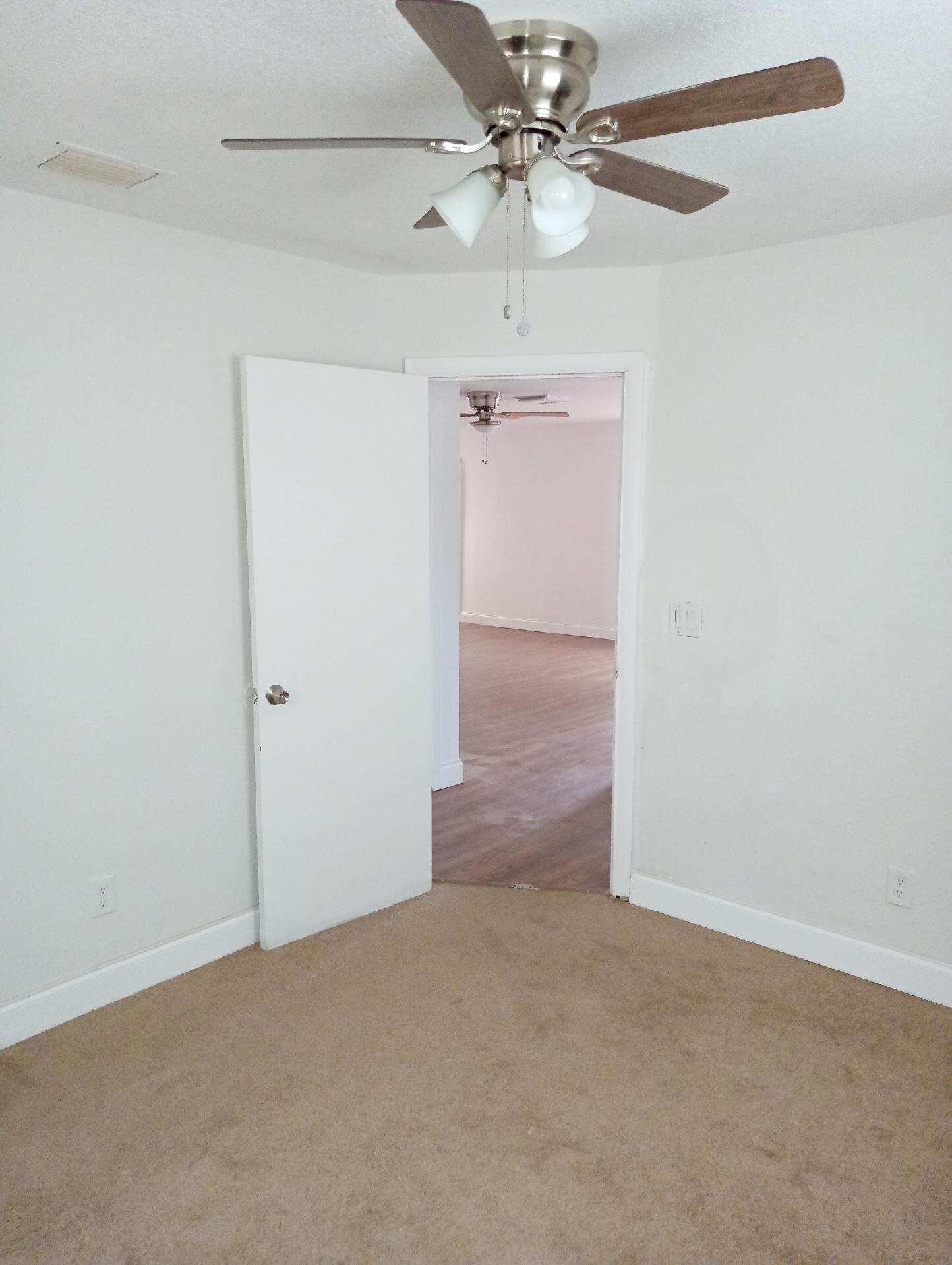 305 Northwest 4th Avenue Delray Beach, FL 33444 - Photo 5 of 45 an empty room with a fan & a ceiling fan