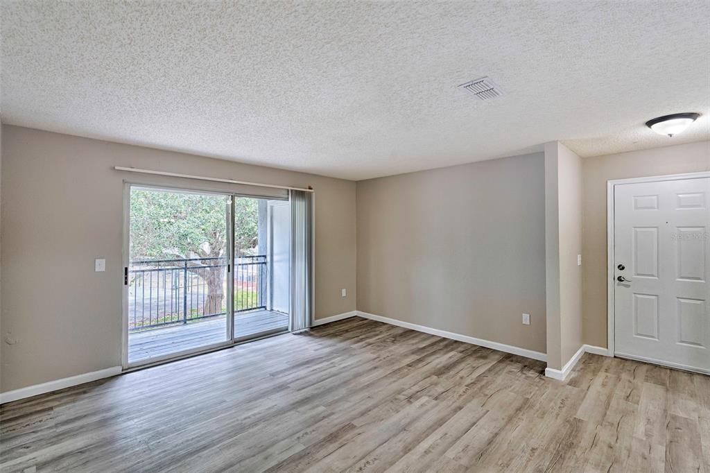 3705 Southwest 27th Street, Unit 926 Gainesville, FL 32608 - Photo 11 of 39 a view of an empty room with wooden floor and a window