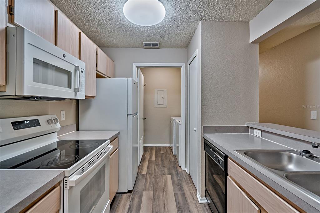 3705 Southwest 27th Street, Unit 926 Gainesville, FL 32608 - Photo 15 of 39 a kitchen with stainless steel appliances granite countertop a sink stove and refrigerator