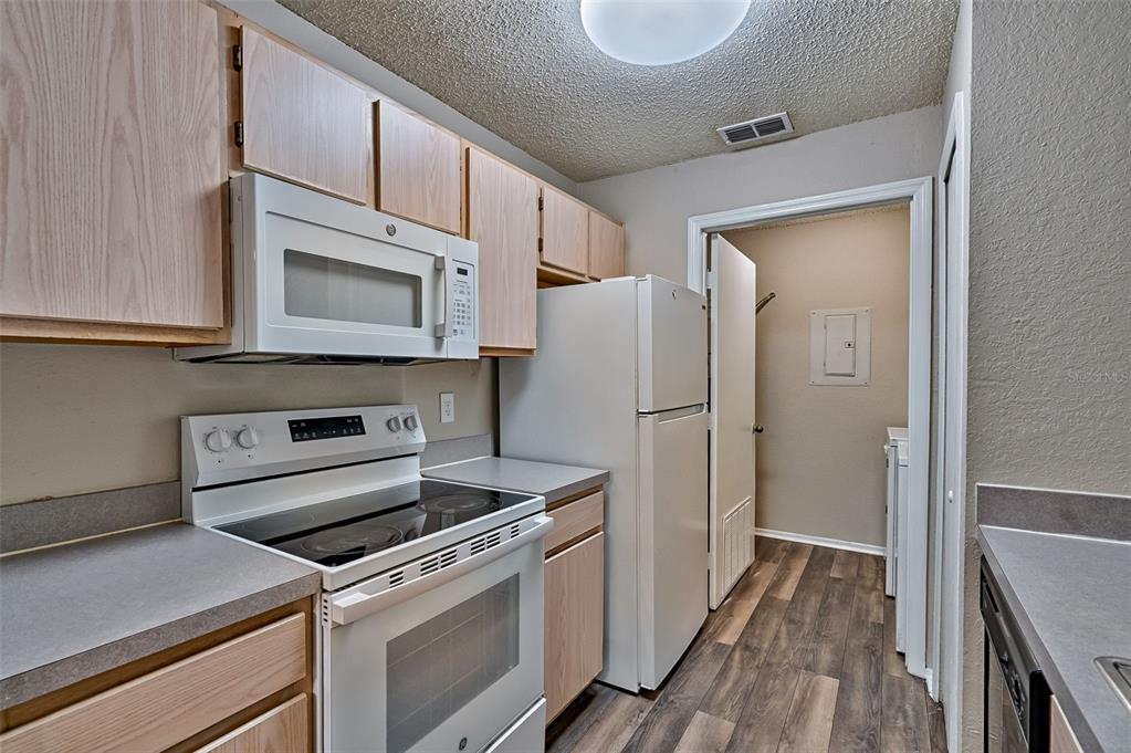 3705 Southwest 27th Street, Unit 926 Gainesville, FL 32608 - Photo 16 of 39 a kitchen with a refrigerator stove and cabinets