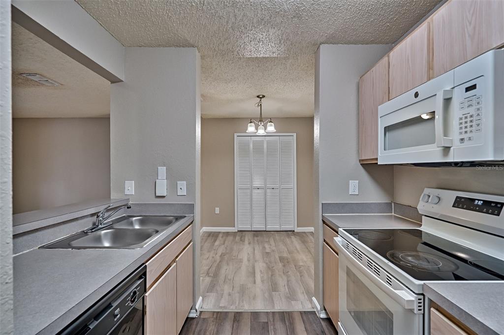 3705 Southwest 27th Street, Unit 926 Gainesville, FL 32608 - Photo 17 of 39 a kitchen with a sink stove and cabinets