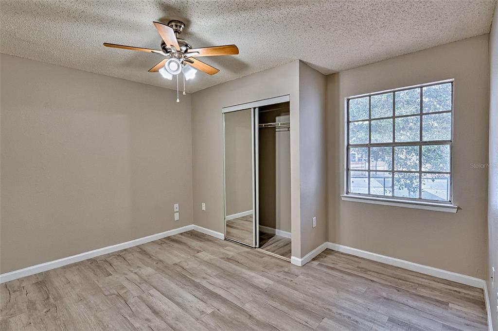 3705 Southwest 27th Street, Unit 926 Gainesville, FL 32608 - Photo 20 of 39 an empty room with wooden floor and chandelier fan