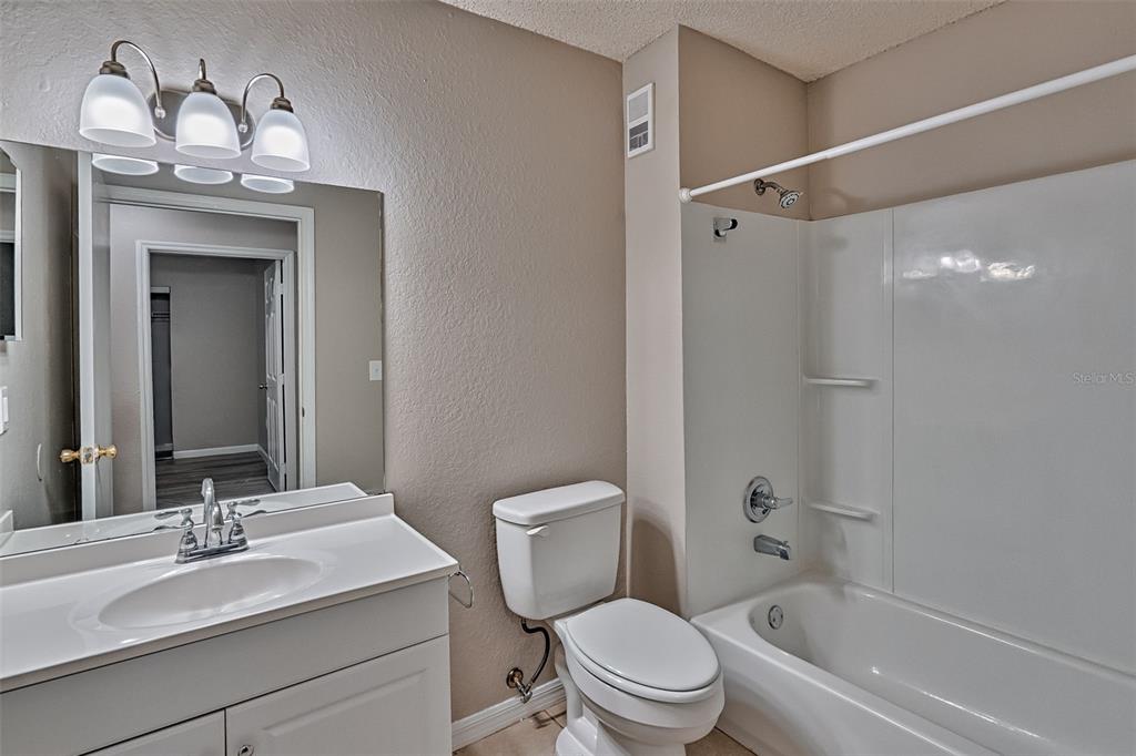 3705 Southwest 27th Street, Unit 926 Gainesville, FL 32608 - Photo 21 of 39 a bathroom with a granite countertop sink toilet and shower