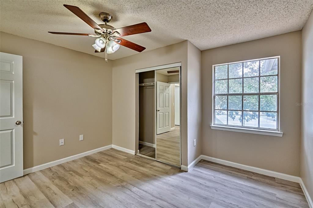 3705 Southwest 27th Street, Unit 926 Gainesville, FL 32608 - Photo 22 of 39 a view of an empty room with wooden floor and a window