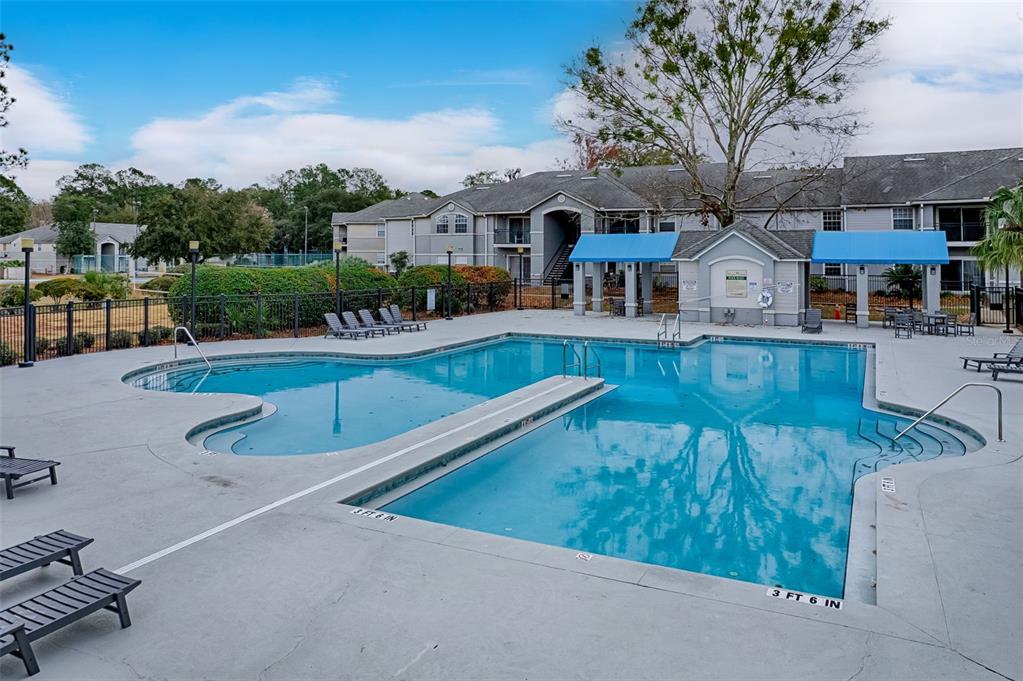 3705 Southwest 27th Street, Unit 926 Gainesville, FL 32608 - Photo 36 of 39 swimming pool view with a seating space and a garden view
