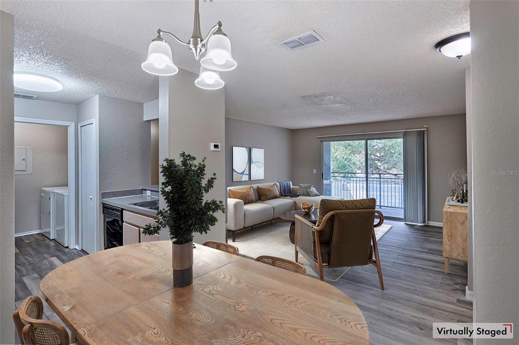 3705 Southwest 27th Street, Unit 926 Gainesville, FL 32608 - Photo 4 of 39 a living room with furniture potted plant and a chandelier